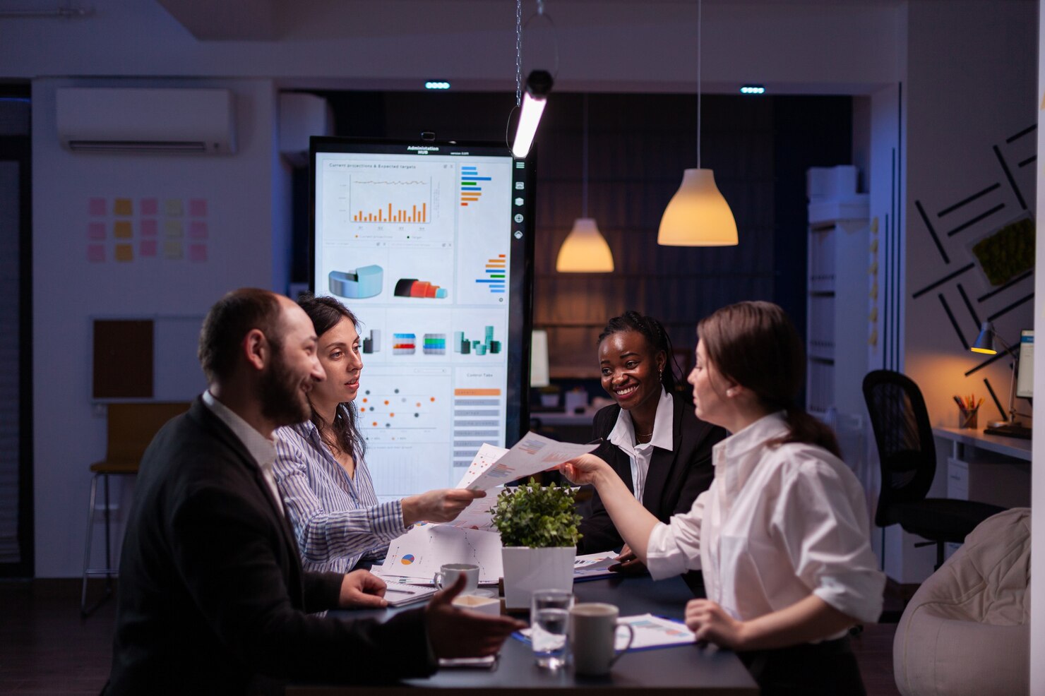 workaholics-businesspeople-brainstorming-financial-company-ideas-analyzing-strategy-paperwork-late-night-business-office-meeting-room_482257-2170
